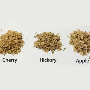 Various natural BBQ wood smoking chips: cherry, hickory, and apple flavors for grilling