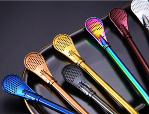 Macro view of colorful 304 stainless steel filter straw spoons on a black tray