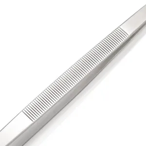 Detailed macro view of the non-slip serrated handle on stainless steel kitchen tweezers
