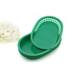 Durable green oval plastic food baskets for serving hot dogs and snacks at picnics