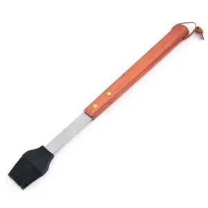 Detailed macro view of a heat-resistant silicone BBQ brush with long wooden handle