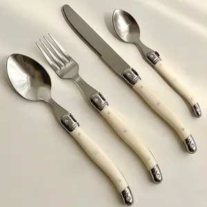 High-quality 4-piece cream white Laguiole style stainless steel cutlery set with curved handles