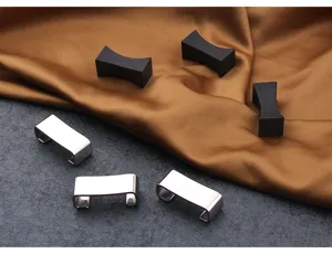 Macro view of matte black and polished silver chopstick rests on silk fabric