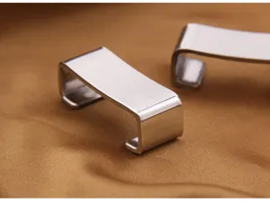 Macro detail of minimalist stainless steel chopstick rest with polished metallic finish