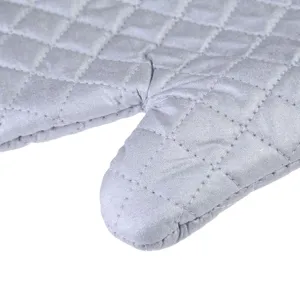 Macro view of silver quilted stitching on a durable heat resistant kitchen oven mitt