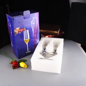Detail view of the crystal champagne glass set in protective foam packaging, ready for weddings.