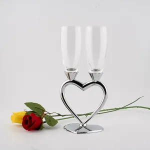 Detail view of heart-shaped base crystal champagne glasses set, elegant wedding party goblet.