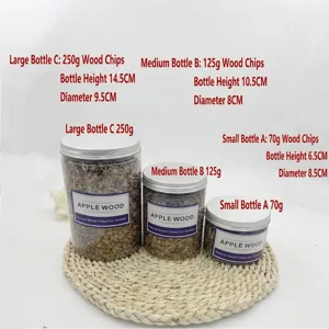 Macro view showing natural apple wood chips in small, medium, and large jars for food smoking