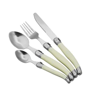 Detailed view of 4-piece stainless steel flatware set with milky white curved handles