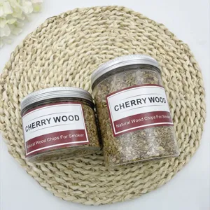 Detail view of two jars of natural cherry wood chips for cocktail smoker on a woven straw mat