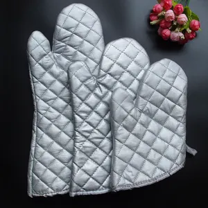 Set of silver heat resistant quilted oven mitts for kitchen baking and grilling