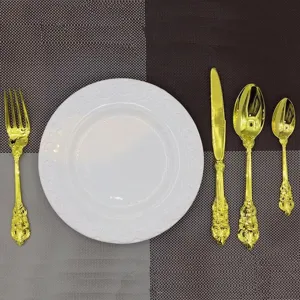 Vintage gold-plated 4-piece cutlery set with ornate embossed handles and white plate