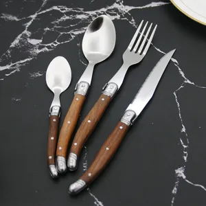 Detail view of a 4-piece Laguiole-style cutlery set with elegant wooden handles.