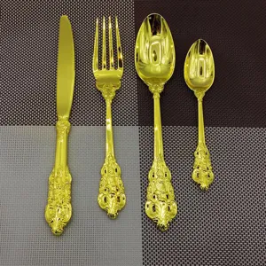 Detailed look at a 4-piece vintage gold-plated cutlery set with ornate palace style handles