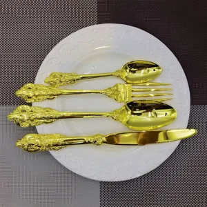 Detail view of 4-piece vintage gold cutlery set on an elegant white plate