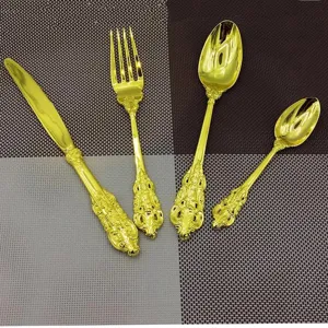 Detail view of vintage gold cutlery set with exquisite embossed baroque style handles