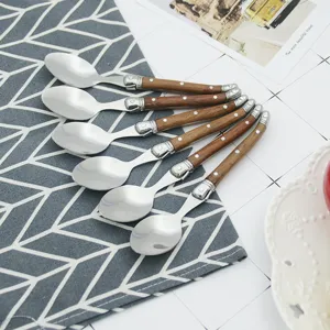 Close-up of six Laguiole-style spoons with elegant wooden handles and stainless steel heads.