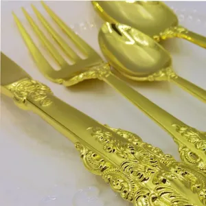 Detailed macro shot of intricate vintage patterns on gold-plated luxury cutlery set