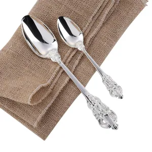 Close-up detail of vintage palace-style silver spoons featuring intricate floral patterns