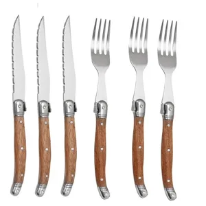 Premium Laguiole style steak knife and fork set featuring elegant wooden handles and rivets