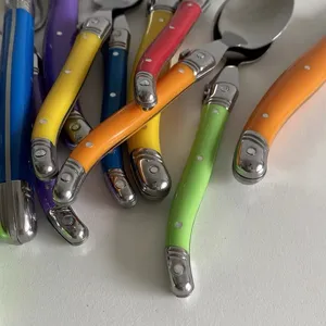 Detailed close-up view of vibrant multi-colored cutlery handles in French Laguiole style