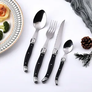 Close-up of Laguiole style black and silver stainless steel cutlery set for elegant dining
