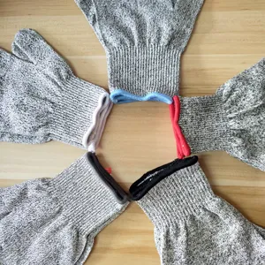 Level 5 cut resistant work gloves with multi-colored elastic cuffs on wood background