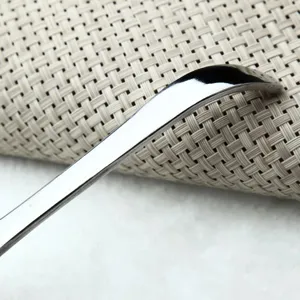 Close-up detail of a thick stainless steel spoon handle with a premium mirror polished finish