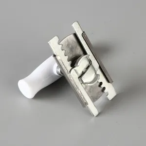 Close-up detail of a manual adjustable stainless steel jar opener with a white ergonomic handle