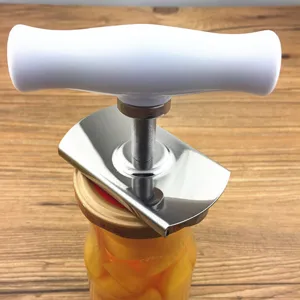 Detail view of adjustable stainless steel jar opener tool in use on a glass jar