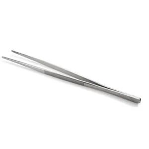 Macro view of professional stainless steel kitchen tweezers for precision BBQ cooking