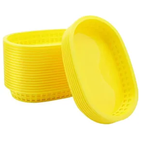 Detail view of a stack of oval yellow plastic food baskets for restaurants and picnics