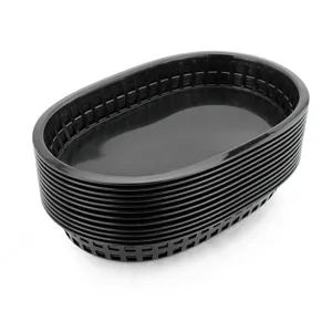 Stack of black oval plastic fast food baskets for restaurant table service