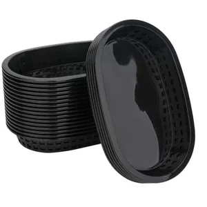 Stack of black oval plastic food baskets for serving hot dogs and fries in restaurants.