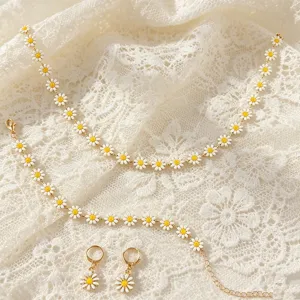 Detailed view of Bohemian daisy necklace bracelet and earrings set on lace background