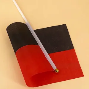 Handheld bicolor black and red flag on white pole with gold ball finial for events.