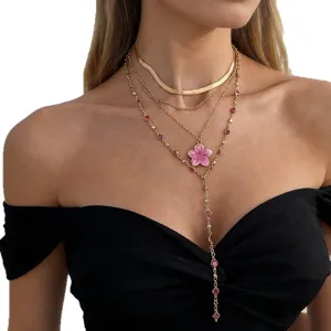 Elegant gold layered necklace set with pink flower pendant and crystal beads on model