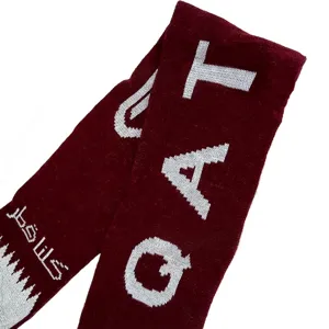 Detailed view of maroon acrylic jacquard knitted scarf with Qatar flag theme pattern
