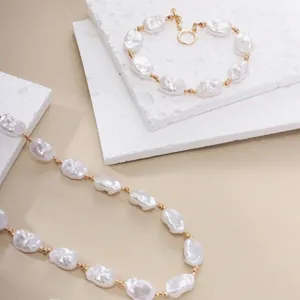 Detailed view of a vintage baroque pearl necklace and bracelet set with golden OT buckle.