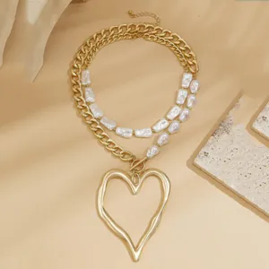 Detailed view of baroque pearl double-layer necklace with large molten heart pendant