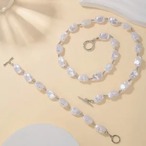 Detailed view of irregular Baroque pearl necklace and bracelet set with silver OT clasp