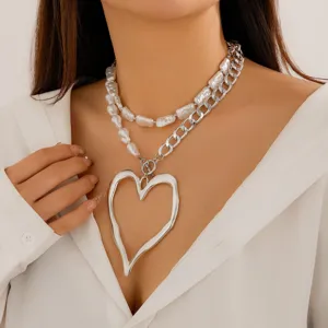 Detailed view of baroque pearl and silver lava heart double-layer necklace