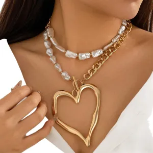 Double-layer necklace with baroque faux pearls and a large gold lava heart pendant