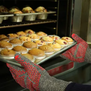 Detailed view of heat resistant oven gloves with red silicone dots, ideal for baking and BBQ.