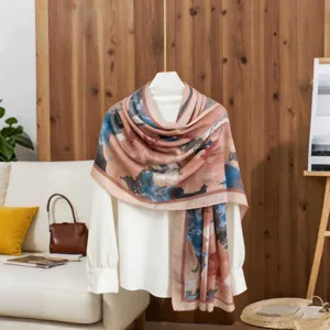 Detailed view of abstract floral cotton linen scarf draped over a white blouse in a home setting