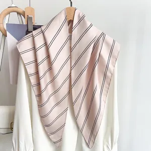 Close-up of elegant retro striped triangular silk scarf in nude pink with black lines