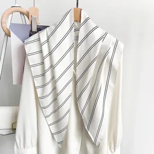 Detailed macro view of a white vintage striped silk scarf shawl accessory on a blouse