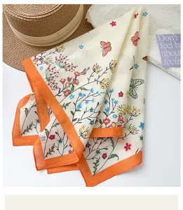 Detail shot of pastoral cotton scarf featuring butterfly and vibrant floral prints