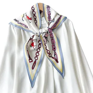 Elegant chain print triangle silk scarf styled on a white shirt fashion accessory