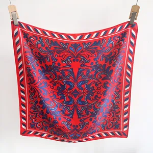 Detailed view of red and blue baroque pattern on a square silk-like scarf hanging